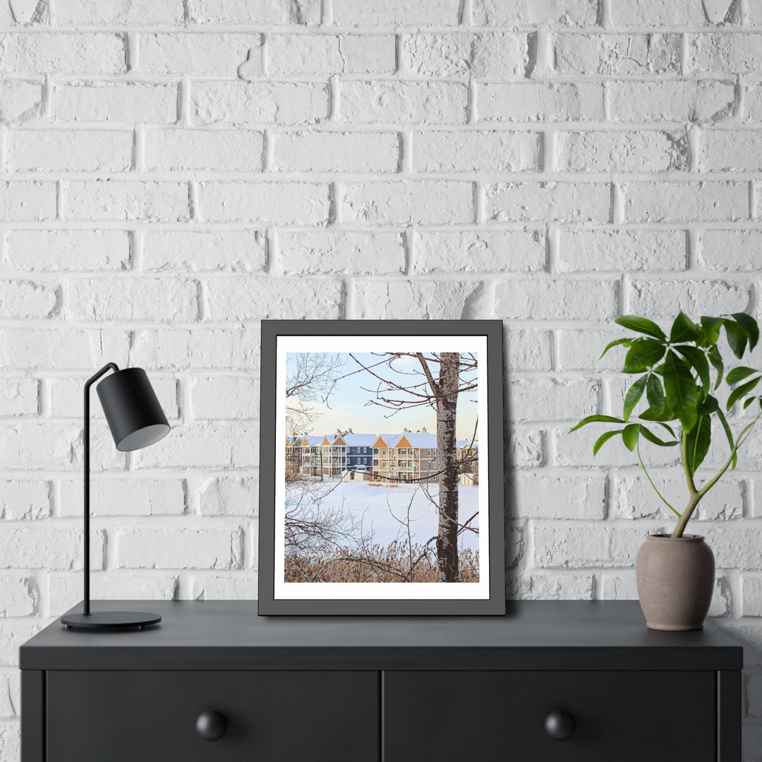 Bromont Quebec scene in a framed winter landscape art on a black dresser with white brick wall. - Bromont Media