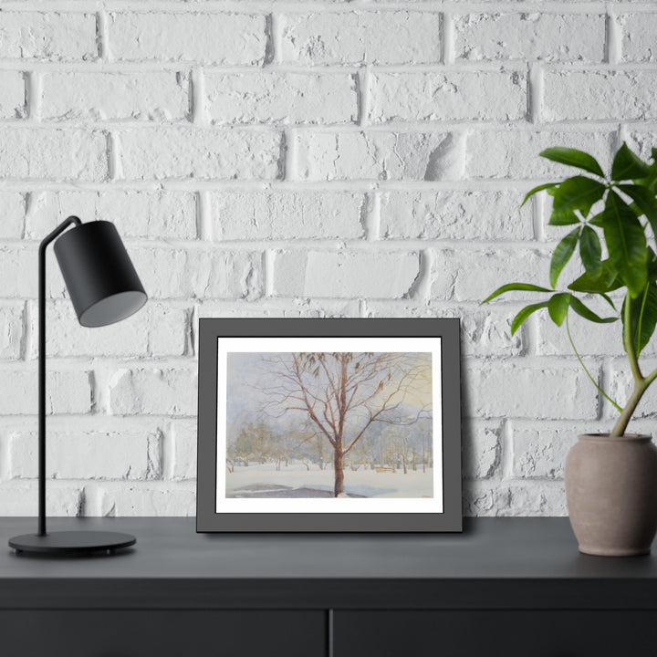 Westmount Park, Quebec: Framed winter painting on black dresser with lamp, plant, and brick wall. - Bromont Media