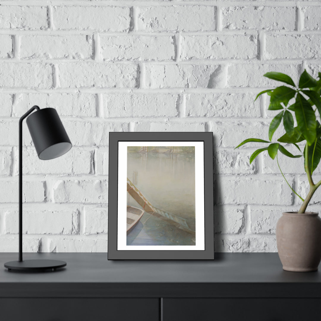 Framed watercolor painting by Veronique Semple showcasing a misty lakeside scene with a boat, displayed on a modern black table with a lamp and potted plant. - Bromont Media